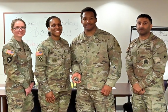 1st Lt. Natalia Khalifa, 1946th Theater Finance Company commander; Command Sgt. Maj. L. Allen, U.S. Army Financial Management Command senior enlisted advisor; with Spc. Devin Montgomery, 1946th Theater Finance Company disbursing analyst; and 1st Sgt. Sahib Singh, 1946th T-FICO first sergeant, pose for a photo at Joint Base Anacostia-Bolling, Washington, D.C., May 4. During her time with the 1946th T-FICO, Allen observed Soldiers conducting training in preparation for their upcoming annual training with a specific focus on disbursing operations. (U.S. Army photo)