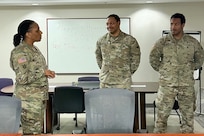 Command Sgt. Maj. L. Allen, U.S. Army Financial Management Command senior enlisted advisor, talks with Spc. Devin Montgomery, 1946th Theater Finance Company disbursing analyst, and Spc. Khalil Ragland, 1946th T-FICO commercial vendor services analyst, at Joint Base Anacostia-Bolling, Washington, D.C., May 4. Allen recognized the two District of Colombia National Guard Soldiers for their dedicated service to the National Guard and the nation. (U.S. Army photo)