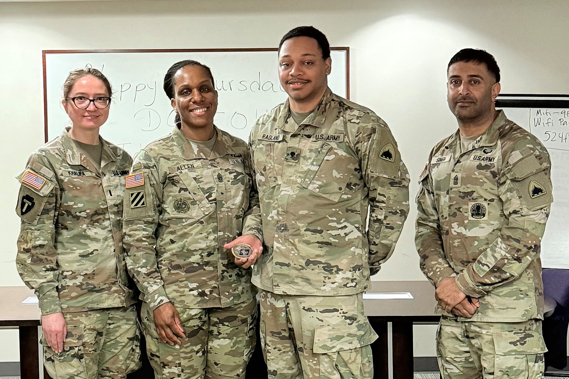 1st Lt. Natalia Khalifa, 1946th Theater Finance Company commander; Command Sgt. Maj. L. Allen, U.S. Army Financial Management Command senior enlisted advisor; Spc. Khalil Ragland, 1946th T-FICO commercial vendor services analyst; and 1st Sgt. Sahib Singh, 1946th T-FICO first sergeant, pose for a photo at Joint Base Anacostia-Bolling, Washington, D.C., May 4. During her time with the 1946th T-FICO, Allen observed Soldiers conducting training in preparation for their upcoming annual training with a specific focus on disbursing operations. (U.S. Army photo)