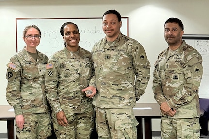1st Lt. Natalia Khalifa, 1946th Theater Finance Company commander; Command Sgt. Maj. L. Allen, U.S. Army Financial Management Command senior enlisted advisor; Spc. Khalil Ragland, 1946th T-FICO commercial vendor services analyst; and 1st Sgt. Sahib Singh, 1946th T-FICO first sergeant, pose for a photo at Joint Base Anacostia-Bolling, Washington, D.C., May 4. During her time with the 1946th T-FICO, Allen observed Soldiers conducting training in preparation for their upcoming annual training with a specific focus on disbursing operations. (U.S. Army photo)