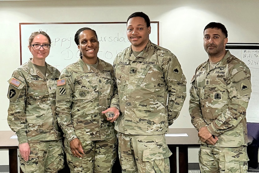 1st Lt. Natalia Khalifa, 1946th Theater Finance Company commander; Command Sgt. Maj. L. Allen, U.S. Army Financial Management Command senior enlisted advisor; Spc. Khalil Ragland, 1946th T-FICO commercial vendor services analyst; and 1st Sgt. Sahib Singh, 1946th T-FICO first sergeant, pose for a photo at Joint Base Anacostia-Bolling, Washington, D.C., May 4. During her time with the 1946th T-FICO, Allen observed Soldiers conducting training in preparation for their upcoming annual training with a specific focus on disbursing operations. (U.S. Army photo)