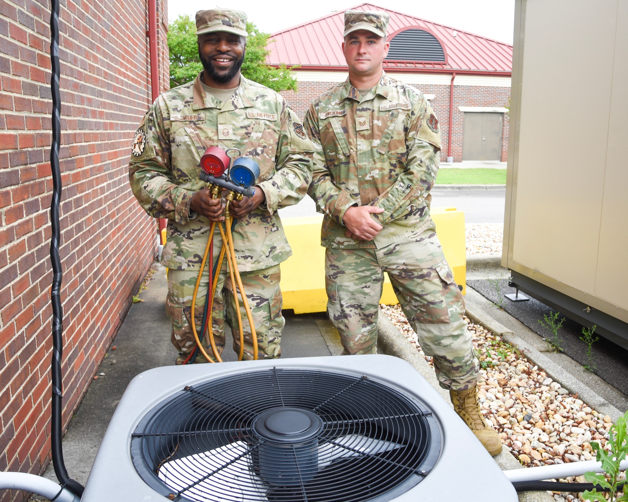 U.S. Air Force personnel conduct maintenance check on HVAC equipment