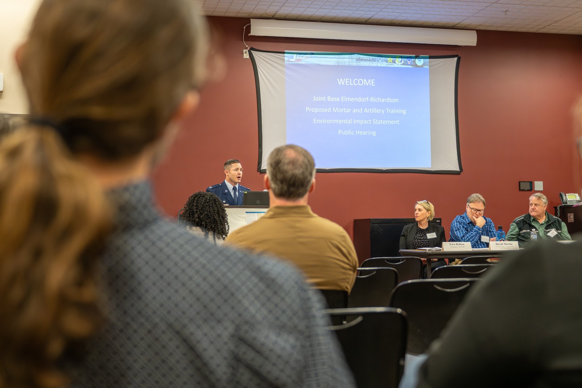 U.S. Air Force Col. Jeremy Oldham, the 673d Civil Engineering Group commander, speaks to an audience at the Proposed Mortar and Artillery Training Environmental Impact Statement public hearing at Eagle River, Alaska.