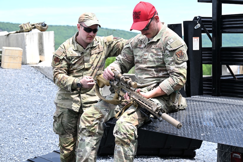 Airman First Class Liam Regan and Staff Sgt Colin King, both assigned to the 107th Attack Wing Security Forces Squadron, inspect the M110A1 sniper rifle before beginning qualification training on May 20, 2025 at Fort Indiantown Gap, PA. Qualification on the M110A1 sniper rifle is limited to those who demonstrate advanced marksmanship and complete the two-week Advanced Designated Marksman Course, held at Fort Bliss, Texas. New York Air National Guard photo by Capt Jason Carr.