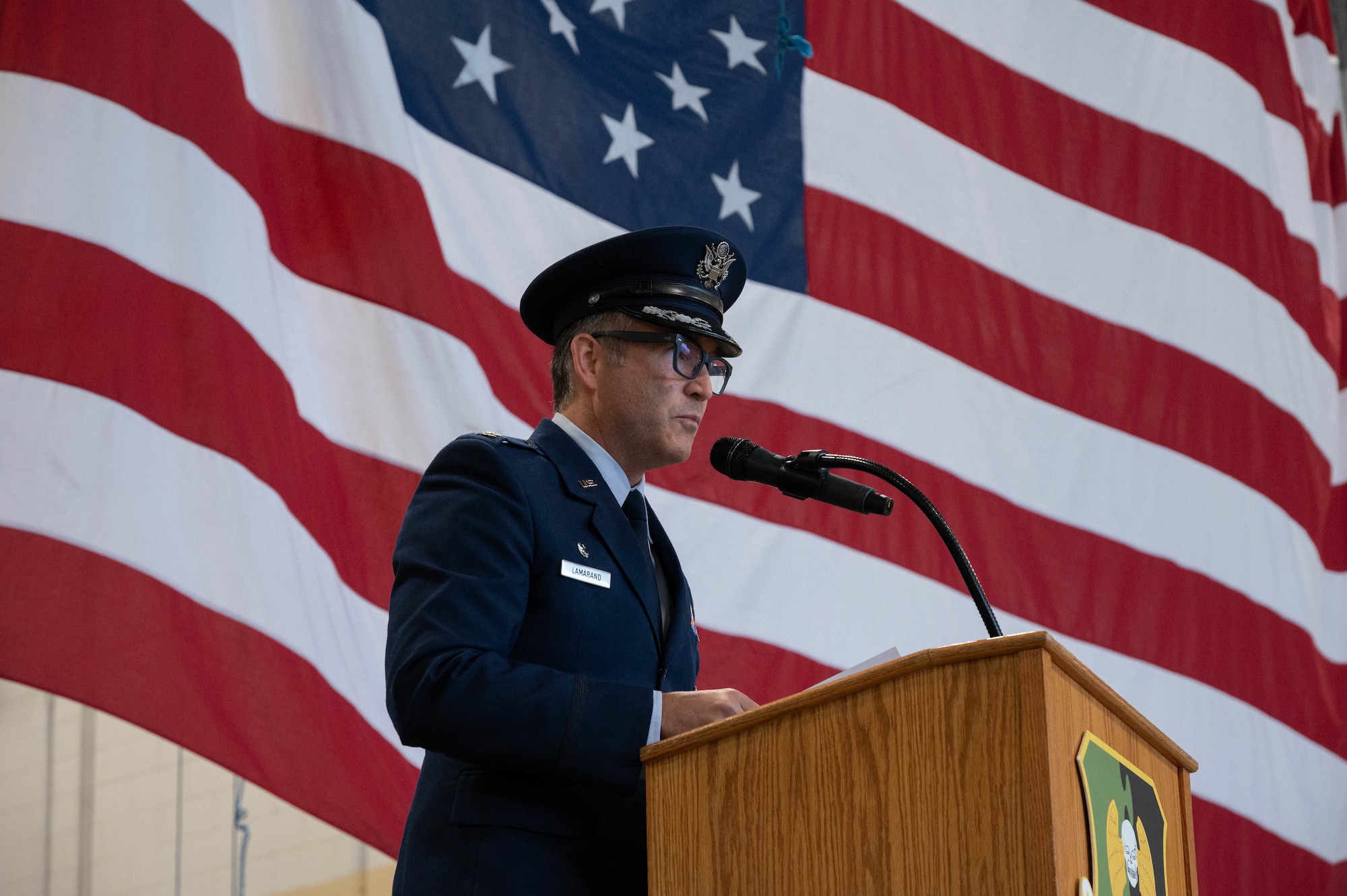 U.S. Air Force Col. Jesse Lamarand, 5th Bomb Wing commander, gives a speech during the change of command ceremony at Minot Air Force Base, North Dakota, June 2, 2025. A change of command ceremony is a formal military tradition that signifies the transfer of authority and responsibility from one commander to another in a public event. (U.S. Air Force photo by Airman 1st Class Wesley Davies)