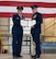 U.S. Air Force Col. Jesse Lamarand, 5th Bomb Wing Commander (left), and U.S. Air Force Col. Jerry Ottinger, 5th Mission Support Group commander (right), pose for a picture with a Legion of Merit award at Minot Air Force Base, North Dakota, June 2, 2025. The Legion of Merit is an award that is earned through exceptionally meritorious conduct in the performance of outstanding services and achievements. (U.S. Air Force photo by Airman 1st Class Wesley Davies)