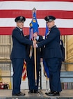 U.S. Air Force Col. Jesse Lamarand, 5th Bomb Wing commander (left), presents U.S. Air Force Col. Jerry Ottinger, 5th Mission Support Group (5MSG) commander (right), with the 5MSG guidon during a change of command ceremony at Minot Air Force Base, North Dakota, June 2, 2025. Ottinger led six squadrons providing full spectrum operational and expeditionary support to the 5th Bomb Wing, the 91st Missile Wing and the 54th Helicopter Squadron, delivering global assurance, precision strike, and nuclear deterrence to six combatant commanders. (U.S. Air Force photo by Airman 1st Class Wesley Davies)
