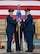 U.S. Air Force Col. Jesse Lamarand, 5th Bomb Wing commander (left), presents U.S. Air Force Col. Jerry Ottinger, 5th Mission Support Group (5MSG) commander (right), with the 5MSG guidon during a change of command ceremony at Minot Air Force Base, North Dakota, June 2, 2025. Ottinger led six squadrons providing full spectrum operational and expeditionary support to the 5th Bomb Wing, the 91st Missile Wing and the 54th Helicopter Squadron, delivering global assurance, precision strike, and nuclear deterrence to six combatant commanders. (U.S. Air Force photo by Airman 1st Class Wesley Davies)