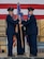 U.S. Air Force Col. Richard Zeigler, incoming 5th Mission Support Group (5MSG) commander (right), accepts the 5MSG guidon from U.S. Air Force Col. Jesse Lamarand, 5th Bomb Wing commander (left), during a change of command ceremony at Minot Air Force Base, North Dakota, June 2, 2025. Lamarand passed the guidon to Zeigler during the ceremony, symbolically passing command of the 5MSG. (U.S. Air Force photo by Airman 1st Class Wesley Davies)