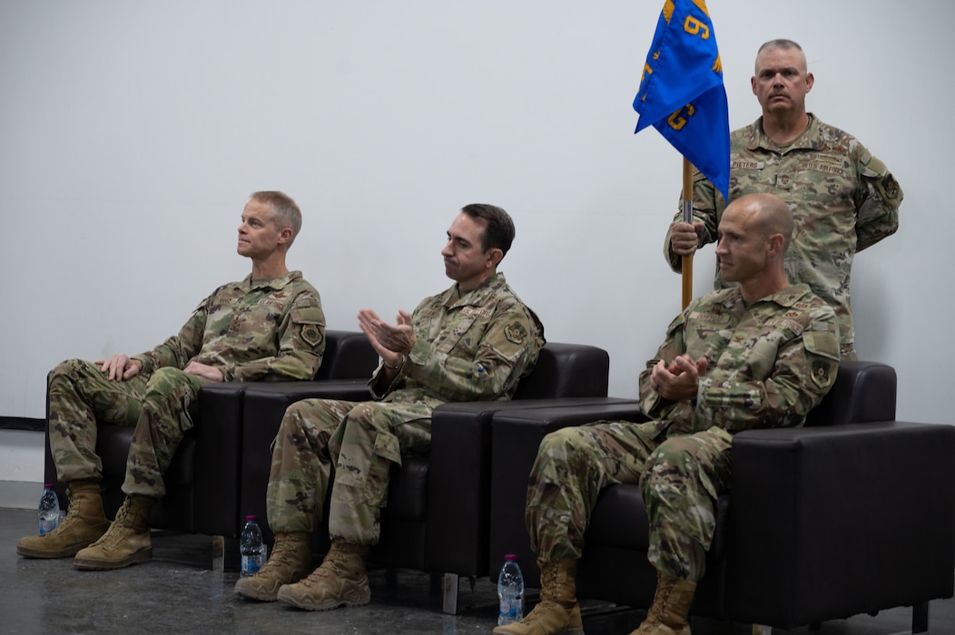 From the left, U.S. Air Force Lt. Gen. Derek France, Ninth Air Force (Air Forces Central) commander, Col. Matthew Borawski, outgoing 1st Expeditionary Theater Support Group commander and Col. Ross E. Dotzlaf, incoming 1st ETSG commander, clap during the change of command ceremony within the U.S. Central Command area of responsibility May 30, 2025. The ceremony saw Borawski relinquish command to Dotzlaf. (U.S. Air Force photo by Senior Airman Dieondiere Jefferies)