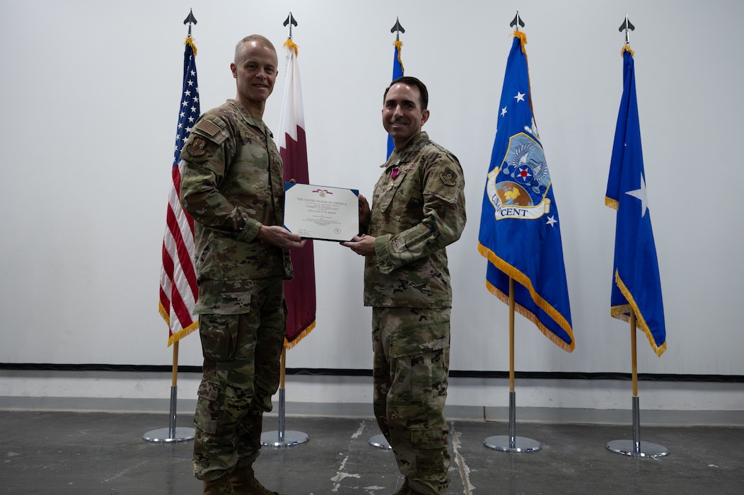 U.S. Air Force Lt. Gen. Derek France, left, Ninth Air Force (Air Forces Central) commander, presents the Legion of Merit to Col. Matthew Borawski, right, outgoing 1st Expeditionary Theater Support Group  commander, during the 1st ETSG change of command ceremony within the U.S. Central Command area of responsibility, May 30, 2025. The ceremony saw Borawski relinquish command to Col. Ross E. Dotzlaf. (U.S. Air Force photo by Senior Airman Dieondiere Jefferies)