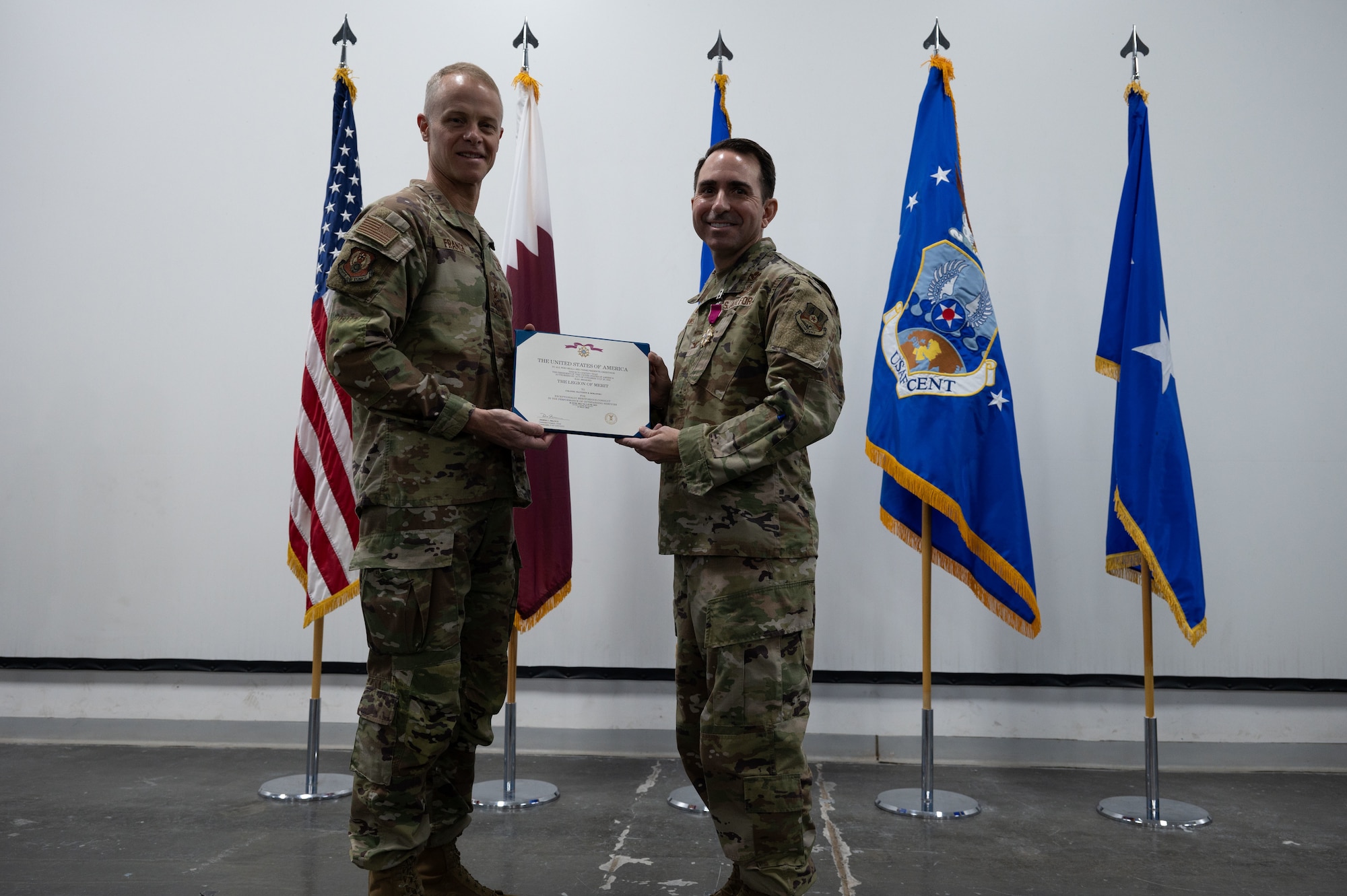 U.S. Air Force Lt. Gen. Derek France, left, Ninth Air Force (Air Forces Central) commander, presents the Legion of Merit to Col. Matthew Borawski, right, outgoing 1st Expeditionary Theater Support Group  commander, during the 1st ETSG change of command ceremony within the U.S. Central Command area of responsibility, May 30, 2025. The ceremony saw Borawski relinquish command to Col. Ross E. Dotzlaf. (U.S. Air Force photo by Senior Airman Dieondiere Jefferies)