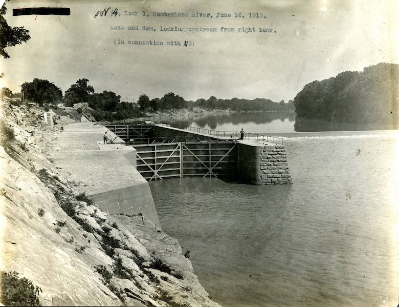 This is Lock and Dam 1 looking upstream from the right bank on the Cumberland River in Nashville, Tennessee, June 16, 1913. The U.S. Army Corps of Engineers Nashville District built the lock and dam to establish a navigation channel. The old locks and dams were later replaced by today's modern dams. (USACE Photo)