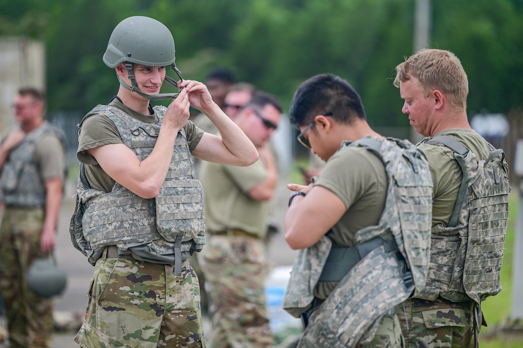 Airmen gather to put on military gear.