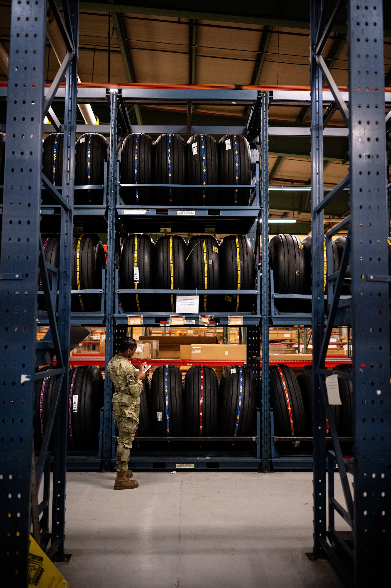 U.S. Airman 1st Class Shanelle King, 436th Logistics Readiness Squadron material management inspection apprentice, writes while inspecting parts at Dover Air Force Base, Delaware, June 2, 2025. As part of the Material Management Flight within the 436th LRS, King is responsible for ensuring compliance and accountability across the base by conducting shelf-life inspections, functional checks and Care of Supplies in Storage (COSIS). She also trains and certifies limited inspectors to maintain readiness across the unit. (U.S. Air Force photo by Staff Sgt. Marco A. Gomez)