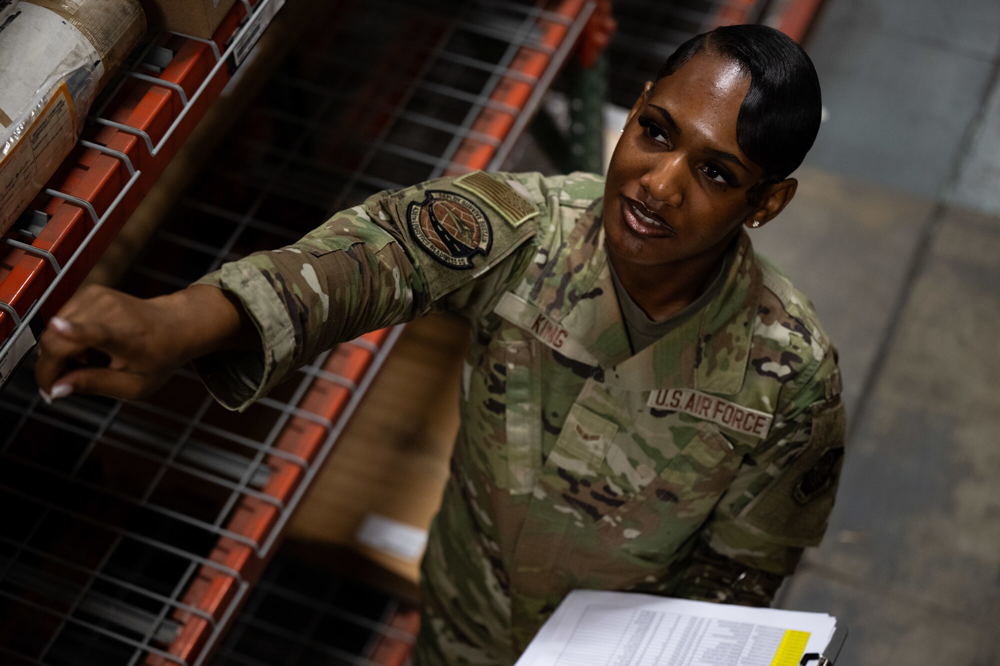 U.S. Airman 1st Class Shanelle King, 436th Logistics Readiness Squadron material management inspection apprentice, points at a label during an inspection at Dover Air Force Base, Delaware, June 2, 2025. As part of the Material Management Flight within the 436th LRS, King is responsible for ensuring compliance and accountability across the base by conducting shelf-life inspections, functional checks and Care of Supplies in Storage (COSIS). She also trains and certifies limited inspectors to maintain readiness across the unit. (U.S. Air Force photo by Airman 1st Class Liberty Matthews)