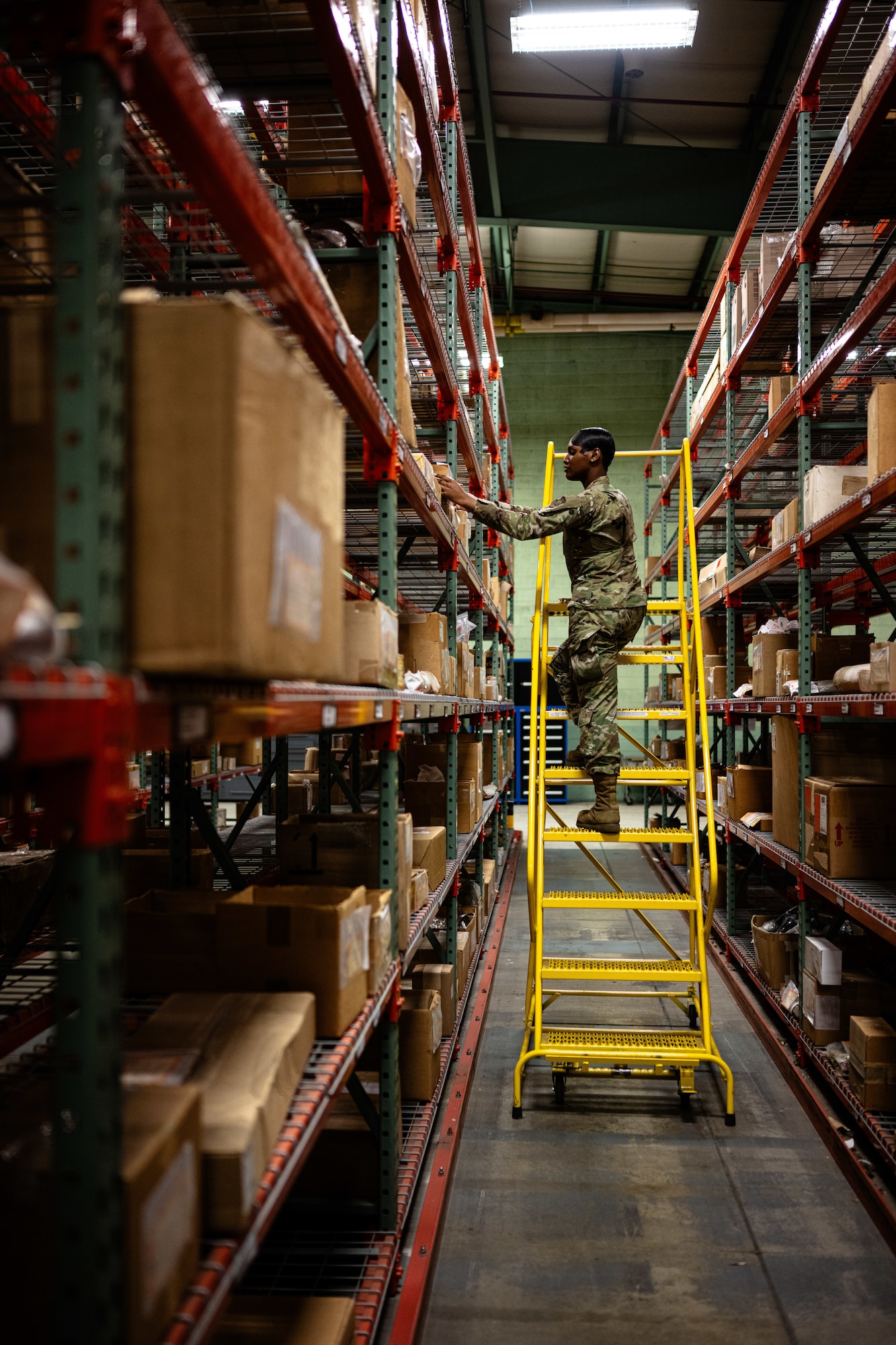 U.S. Airman 1st Class Shanelle King, 436th Logistics Readiness Squadron material management inspection apprentice, grabs a box during parts inspection at Dover Air Force Base, Delaware, June 2, 2025. As part of the Material Management Flight within the 436th LRS, King is responsible for ensuring compliance and accountability across the base by conducting shelf-life inspections, functional checks and Care of Supplies in Storage (COSIS). She also trains and certifies limited inspectors to maintain readiness across the unit. (U.S. Air Force photo by Staff Sgt. Marco A. Gomez)