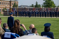 Air and Space Force personnel perform ceremonial assumption of command in dress uniform.