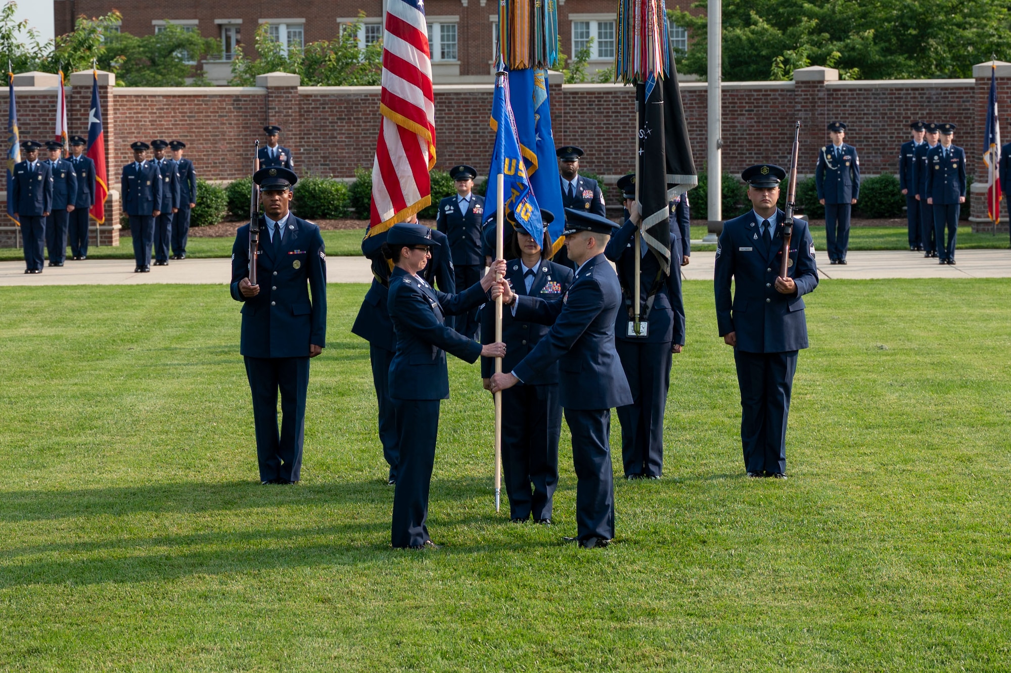Air and Space Force personnel perform ceremonial assumption of command in dress uniform.
