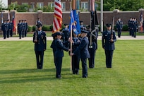 Air and Space Force personnel perform ceremonial assumption of command in dress uniform.
