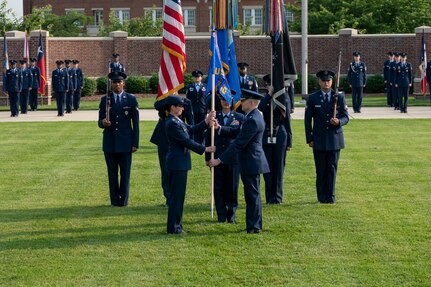 Air and Space Force personnel perform ceremonial assumption of command in dress uniform.