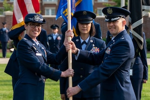 Air and Space Force personnel perform ceremonial assumption of command in dress uniform.