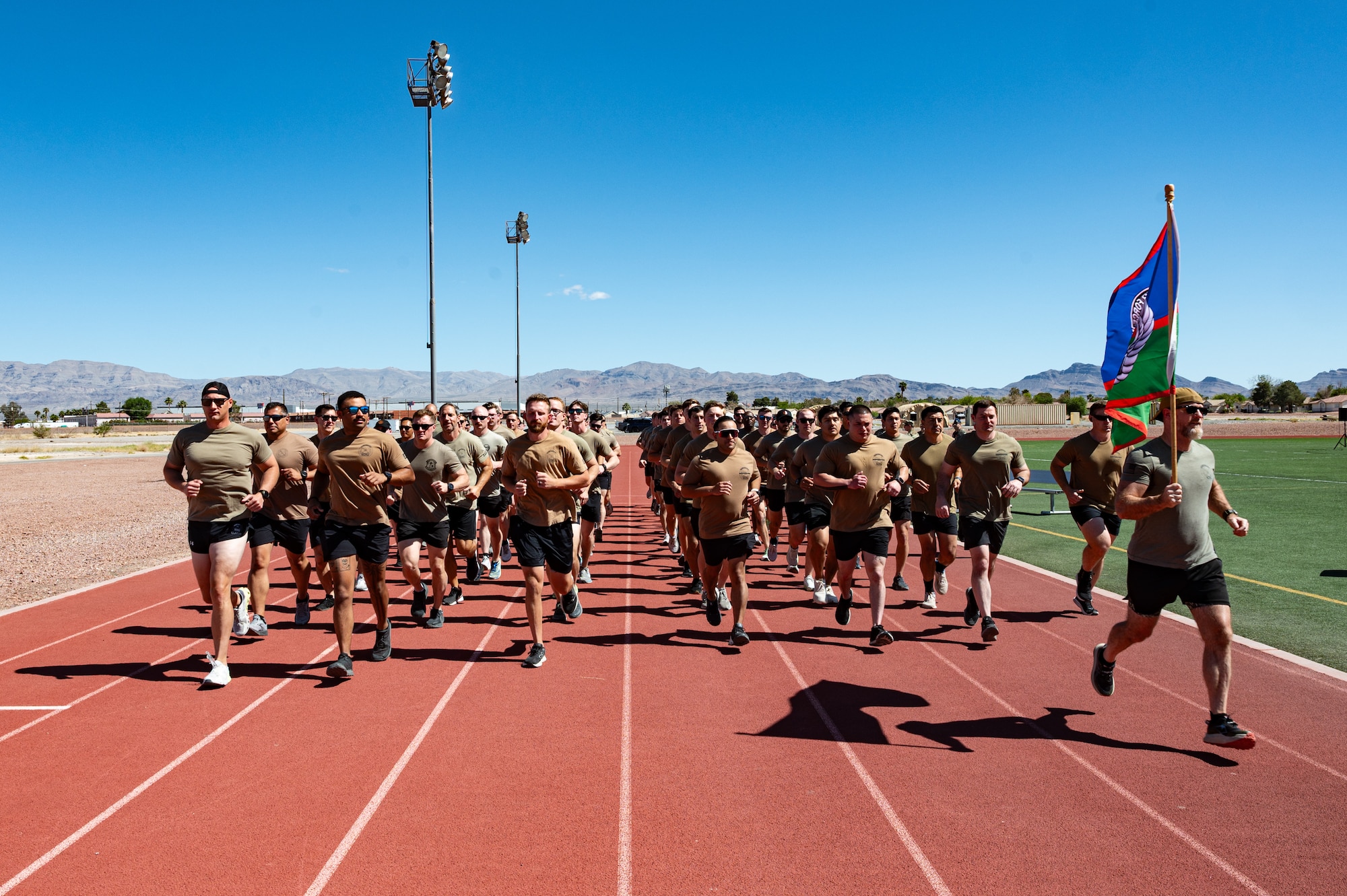 A group of Airmen running on a track.