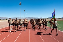 A group of Airmen running on a track.