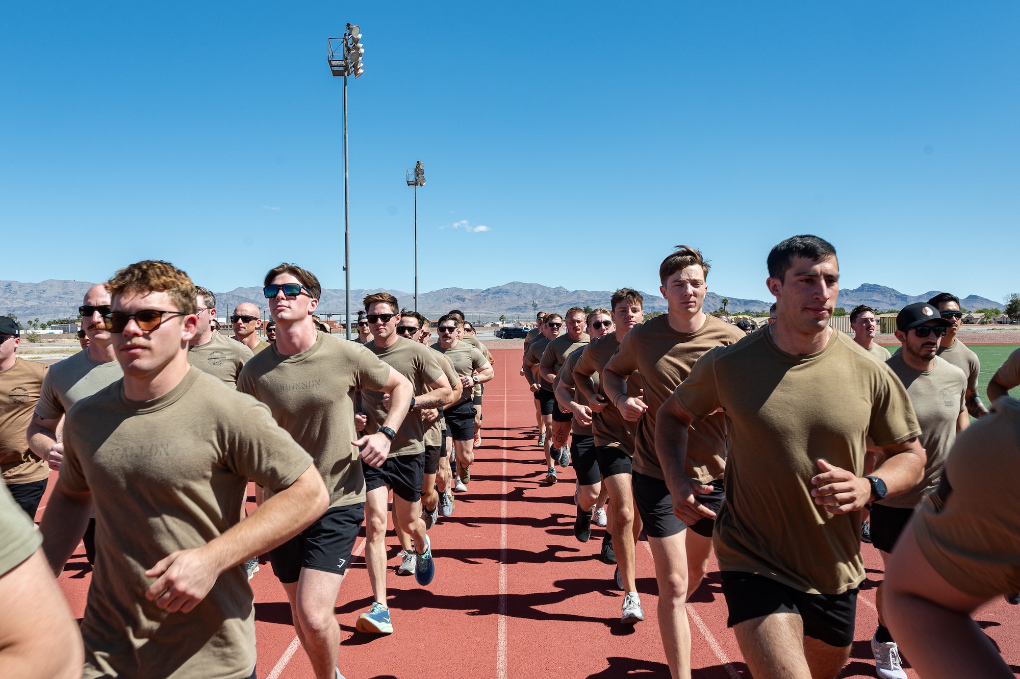 A group of Airmen running on a track