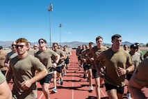 A group of Airmen running on a track