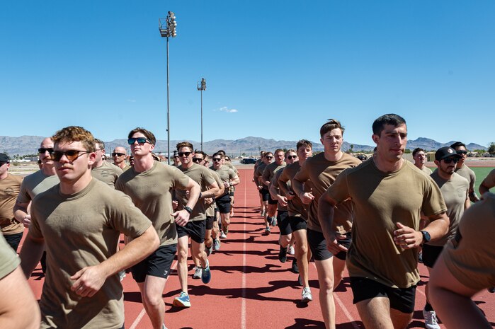 A group of Airmen running on a track