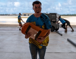 Staff Sgt. Justin Vaught, assigned to the 36th Maintenance Squadron, runs with a sandbag during the Maintenance Olympics at Andersen Air Force Base, Guam, May 30, 2025.