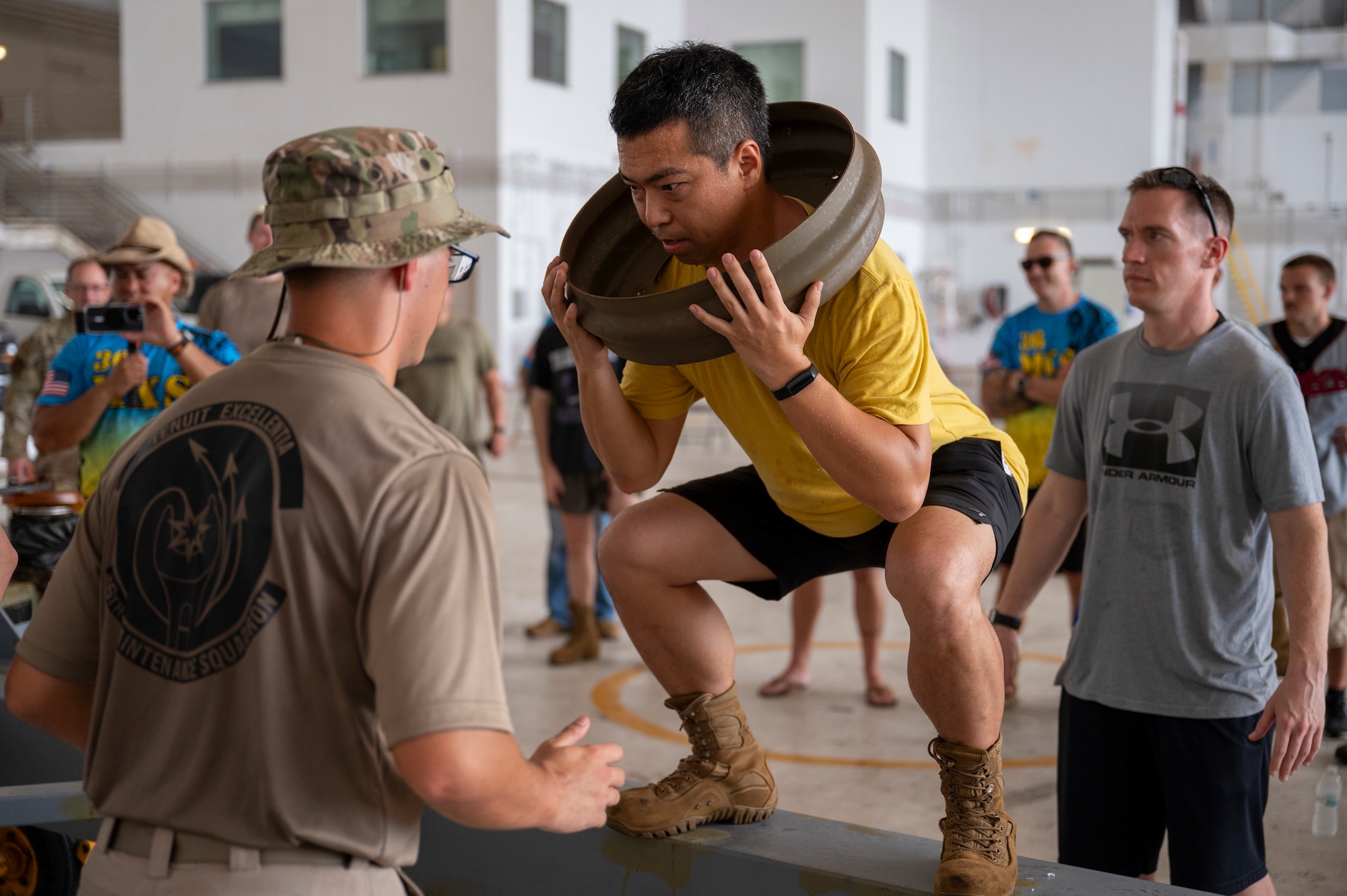From left, Staff Sgt. Baylor Smith, SrA. Dingcheng Jin, and Staff Sgt. Jeffery Gundersen, all assigned to the 36th Maintenance Squadron, participate in the final challenge of the Maintenance Olympics at Andersen Air Force Base, Guam, May 30, 2025.