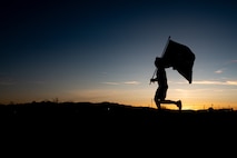 An Airman running during sunset