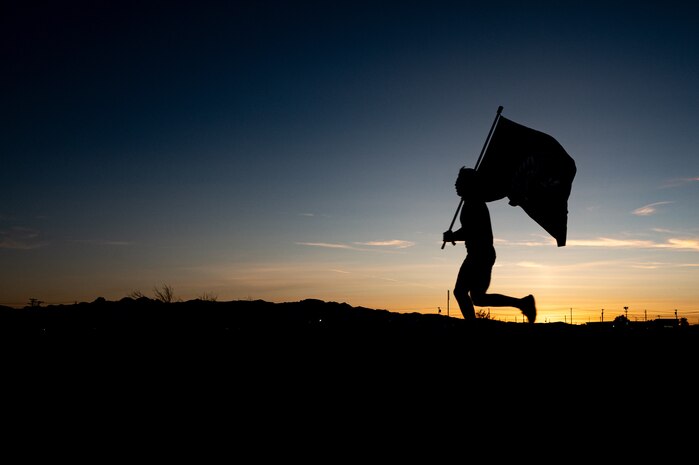 An Airman running during sunset