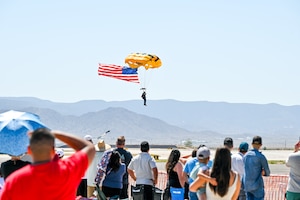 Man parachutes to the ground during the Kirtland Air Fiesta.