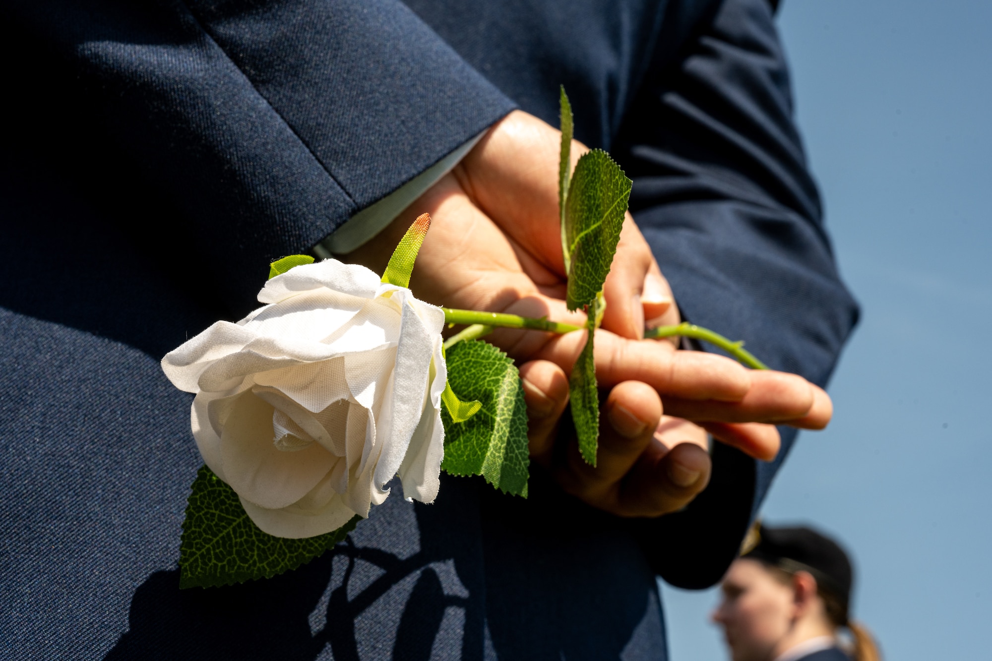 Airman holds a rose