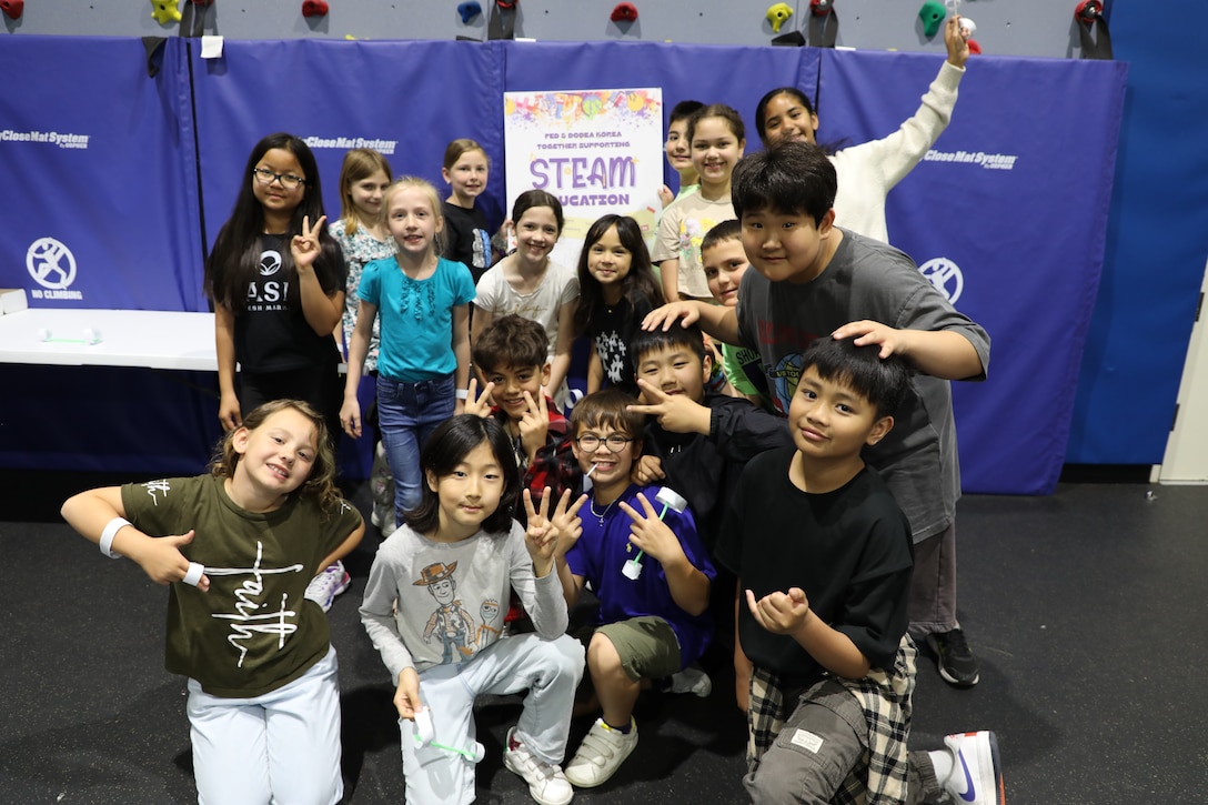 Staff Sgt. Kyler Hughes, Construction Control Representative, U.S. Army Corps of Engineers – Far East District, guides students in creating "Ocean in a Bottle" during a Science, Technology, Engineering, Arts and Mathematics (STEAM) event hosted by USACE at West Elementary School on Camp Humphreys, South Korea, on May 22, 2025. Highlighting the vital role of STEAM in our everyday lives, Hughes sparks excitement for science and engineering in young minds. (U.S. Army photo by Yohan An)