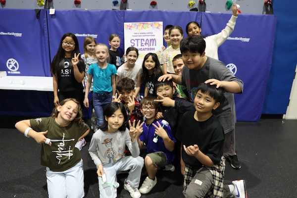 Staff Sgt. Kyler Hughes, Construction Control Representative, U.S. Army Corps of Engineers – Far East District, guides students in creating "Ocean in a Bottle" during a Science, Technology, Engineering, Arts and Mathematics (STEAM) event hosted by USACE at West Elementary School on Camp Humphreys, South Korea, on May 22, 2025. Highlighting the vital role of STEAM in our everyday lives, Hughes sparks excitement for science and engineering in young minds. (U.S. Army photo by Yohan An)
