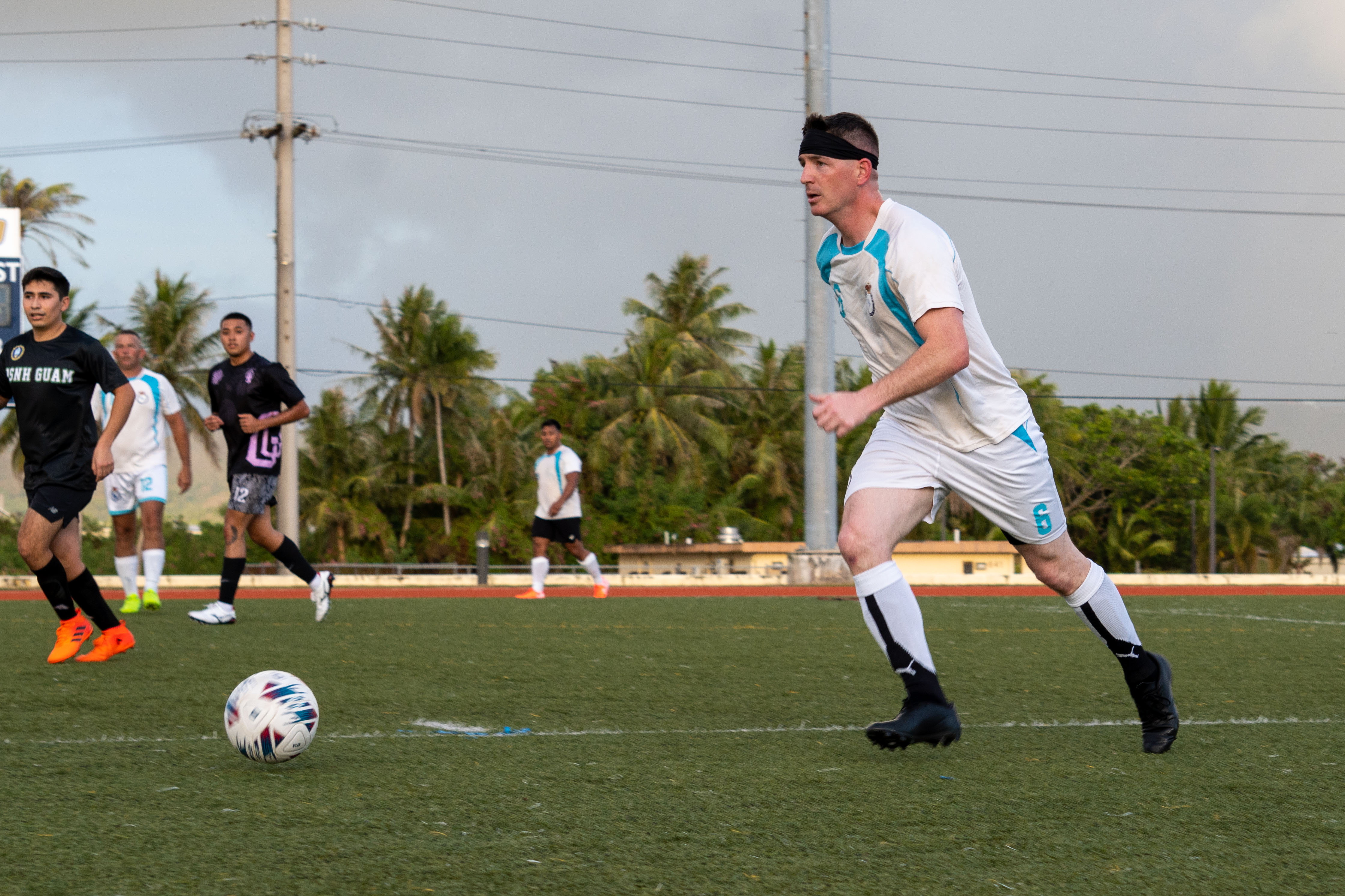 U.S. Marine Corps Staff Sgt. Robert Taylor IV, network chief, Headquarters Company, Marine Corps Base Camp Blaz, prepares to kick the soccer ball to a teammate during an intramural soccer game on Naval Base Guam, Guam, May 16, 2025. MCB Camp Blaz assembled an intramural soccer team, ‘Camp Blaz Boonie Dogs’, to boost camaraderie while representing Camp Blaz in a competitive environment. (U.S. Marine Corps photo by Lance Cpl. Afton Smiley)