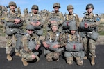 Paratroopers from the Colorado National Guard and the Jordanian Armed Forces stand together before the first joint Colorado-Jordan airborne Friendship Jump, Watkins, Colorado, April 23, 2025. Members parachuted from a CH-47 Chinook as part of an event to strengthen interoperability and deepen the partnership between the two forces.