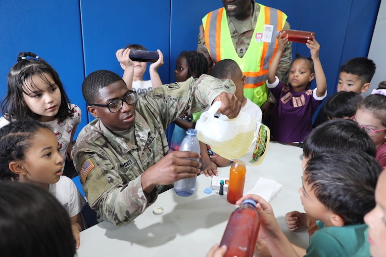 Staff Sgt. Kyler Hughes, Construction Control Representative, U.S. Army Corps of Engineers – Far East District, guides students in creating "Ocean in a Bottle" during a Science, Technology, Engineering, Arts and Mathematics (STEAM) event hosted by USACE at West Elementary School on Camp Humphreys, South Korea, on May 22, 2025. Highlighting the vital role of STEAM in our everyday lives, Hughes sparks excitement for science and engineering in young minds. (U.S. Army photo by Yohan An)