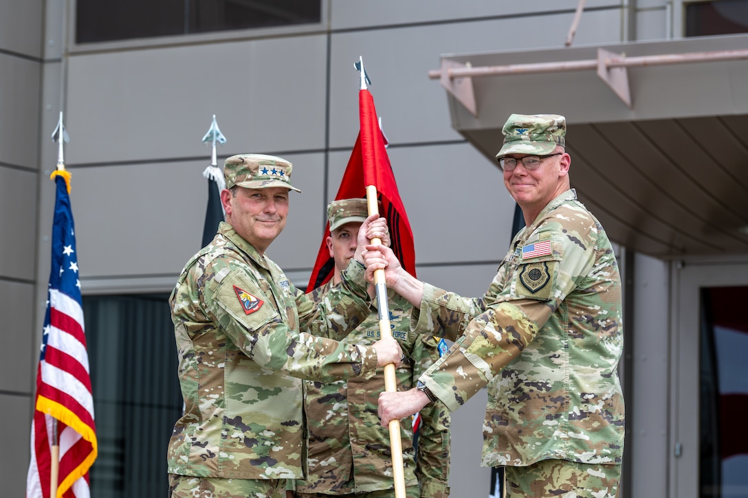 two military men in uniform holding guidon