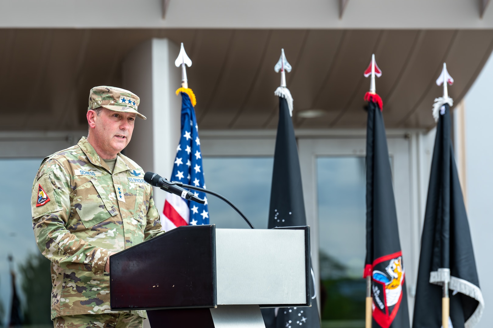 man in uniform speaking at podium