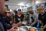 SYDNEY (May 28, 2025) – U.S. Chargé d’Affaires Erika Olson and Sailors assigned to U.S. 7th Fleet and 7th Fleet flagship USS Blue Ridge (LCC 19) prepare food while volunteering with the nonprofit organization Our Big Kitchen during a scheduled port visit in Sydney, May 28, 2025. The Blue Ridge and embarked 7th Fleet staff conduct regular Indo-Pacific patrols to deter aggression, strengthen alliances and partnerships, and advance future warfighting capabilities. (U.S. Navy photo taken by Mass Communication Specialist Seaman Alajia Williams)