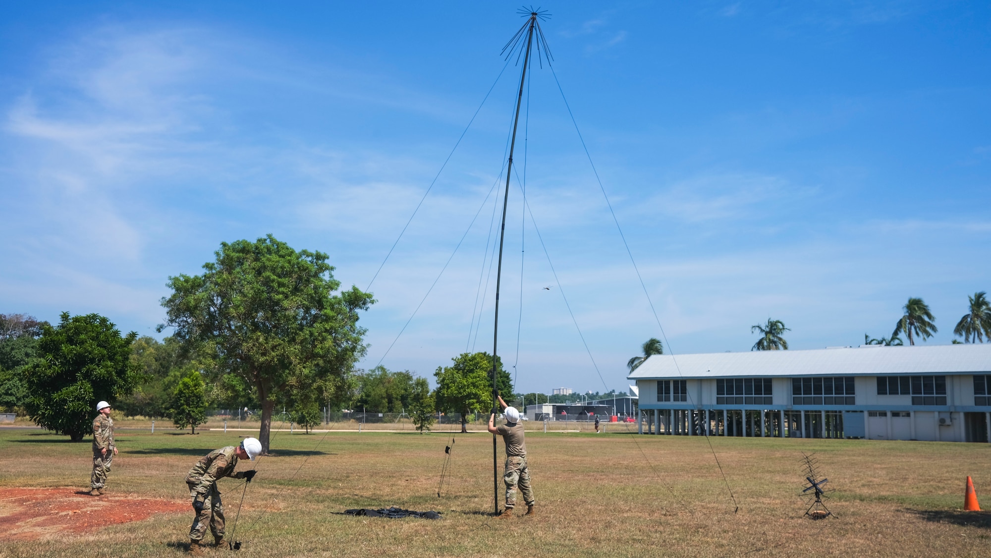 From left, U.S. Air Force Senior Airmen Ismail Buhbaz, Christopher Koon and Jared Nakkashian, 18th Communications Squadron expeditionary communications technicians, establish radio communications during exercise RECCE-Edge  25 at Royal Australian Air Force Base Darwin, Australia, May 20, 2025.