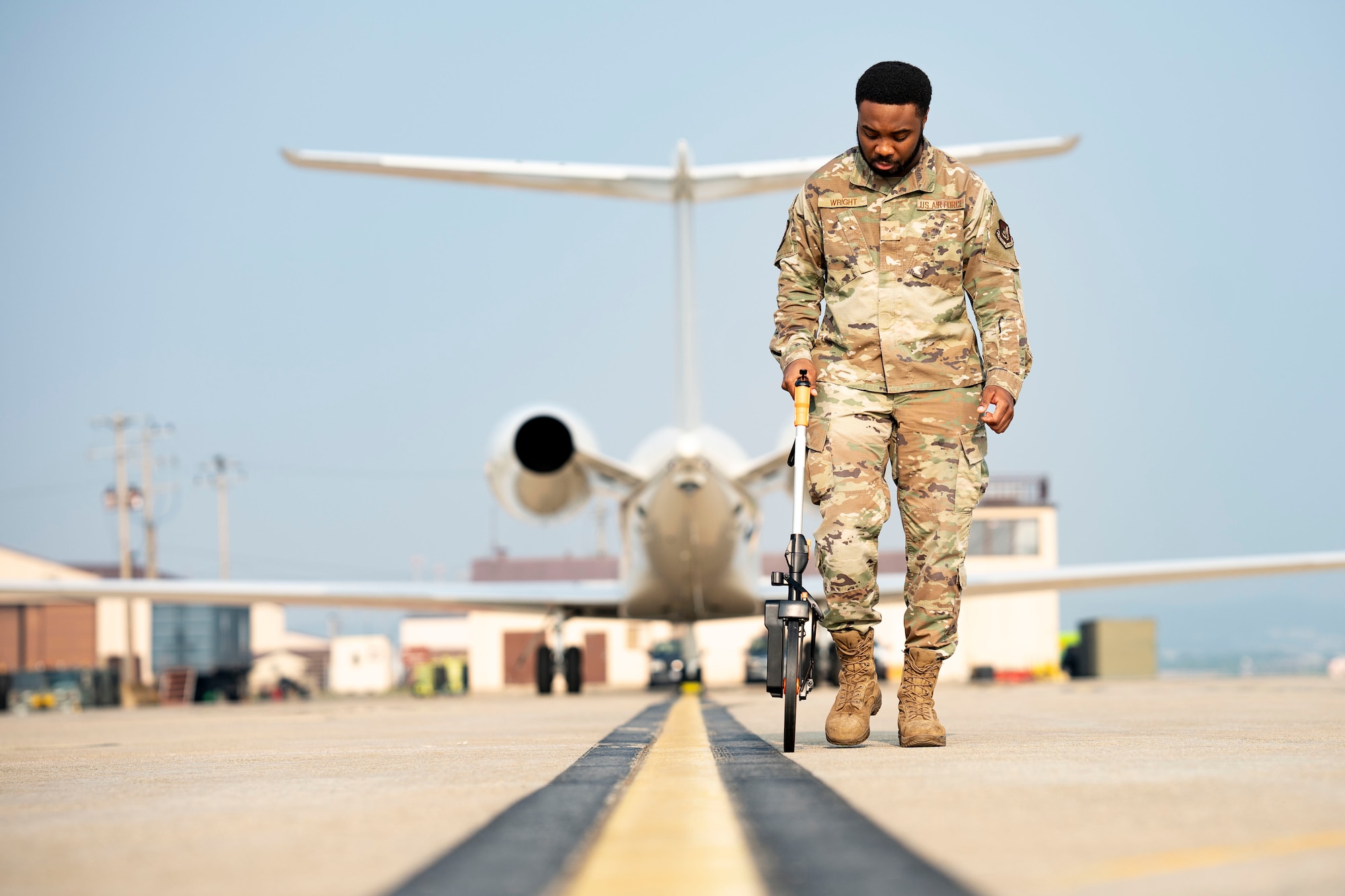 U.S. Air Force Senior Airman Calvin Wright,  airfield management operations supervisor, 51st Operational Support Squadron, conducts a routine flight line inspection at Osan Air Base, Republic of Korea, June 3, 2025.