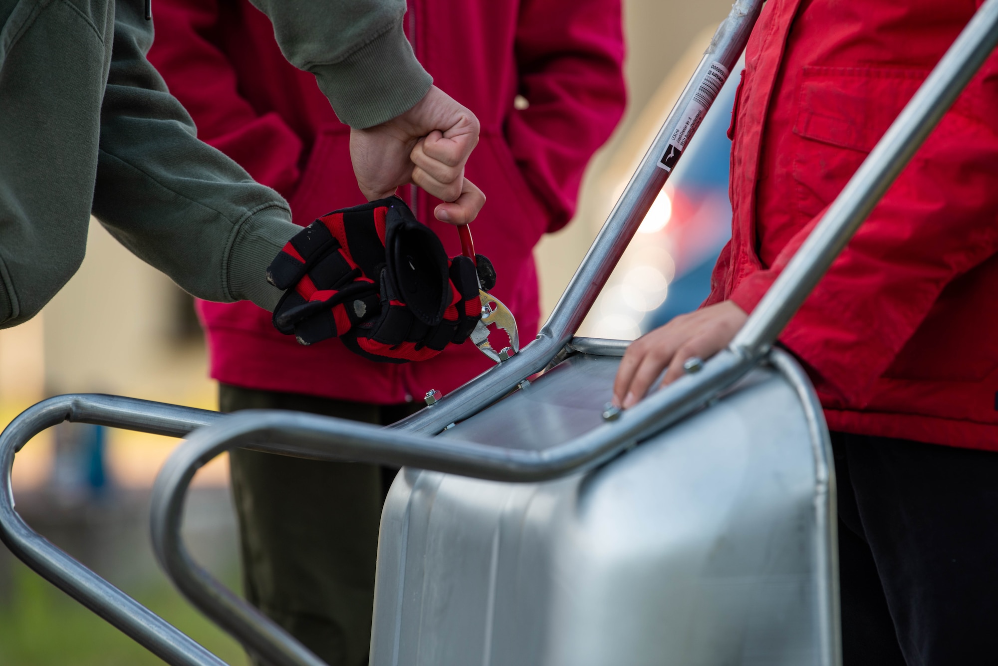 Boy Scouts of America members assemble a wheelbarrow while constructing a disc golf course.