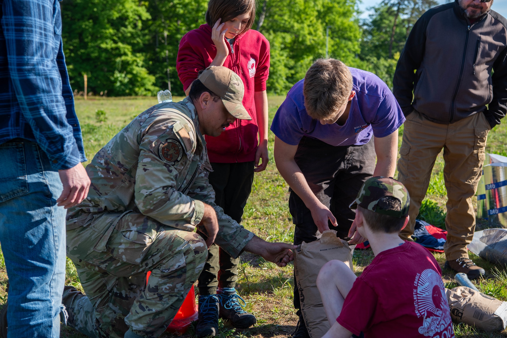 U.S. Air Force Airman 1st Class Uriel Garcia-Fierro, 786th Engineering Squadron pavements and construction specialist, teaches Boy Scouts of America members proper ground preparation while constructing a disc golf course.