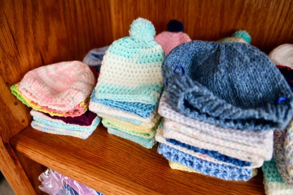 A display of free donated baby items — including handmade hats, blankets, and other gifts — offers comfort and warmth to new parents at Naval Hospital Twentynine Palms. The display, located near the Multi-Service Ward, reflects the community’s support for military families and was featured as part of the ward’s revitalization, officially marked during a ribbon-cutting ceremony on May 29 (U.S. Navy photo by Christopher C. Jones, NHTP/NMRTC Twentynine Palms public affairs officer).